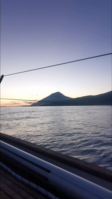 As Pico rises from the horizon, it feels less like an island and more like a promise.
After days at sea, its peak stands silent and eternal, welcoming us with the kind of presence that only mountains born from fire can have. I dream with a house that I will build on it's slope one day. 

The sun slips behind its slopes, painting the sky in gold and violet, and we know—we have arrived. Not just to land, but to a place that has lived in the dreams of countless sailors before us.